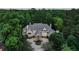 Stunning front exterior of a grand estate, featuring a circular driveway, manicured landscaping, and elegant architectural details at 510 Covington Cv, Alpharetta, GA 30022
