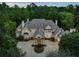 Elegant home showcasing a grand entrance, stately columns, and beautifully landscaped front yard, perfect for a luxurious lifestyle at 510 Covington Cv, Alpharetta, GA 30022