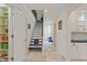 Hallway with staircase, travertine floors and built-in shelving at 510 Covington Cv, Alpharetta, GA 30022