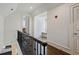 Hallway featuring hardwood floors, natural light, and views into adjacent rooms at 510 Covington Cv, Alpharetta, GA 30022