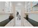 Hallway with glass door cabinets and a view into the dining room at 510 Covington Cv, Alpharetta, GA 30022