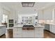 Open kitchen with stainless appliances, granite countertops, and large center island at 510 Covington Cv, Alpharetta, GA 30022
