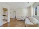 Bright living room with hardwood floors, white trim, and a doorway view to the ensuite bathroom at 510 Covington Cv, Alpharetta, GA 30022