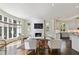 Bright living room with fireplace, television, and adjacent kitchen at 510 Covington Cv, Alpharetta, GA 30022
