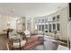 Spacious living room with floor to ceiling windows, fireplace, and hardwood floors at 510 Covington Cv, Alpharetta, GA 30022