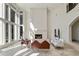 Sun-filled living room with a fireplace, large windows, and elegant seating at 510 Covington Cv, Alpharetta, GA 30022