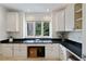 Bright office space features custom white cabinetry, sleek dark countertops, and a large window with a leafy view at 510 Covington Cv, Alpharetta, GA 30022