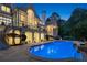 Backyard pool view showing stairs leading to a patio, columns, and large windows at 510 Covington Cv, Alpharetta, GA 30022