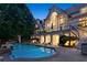 Backyard features a pool with a hot tub, outdoor kitchen and lounge seating area at 510 Covington Cv, Alpharetta, GA 30022