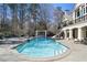 Backyard pool with stone features, an outdoor kitchen, and comfortable lounge seating at 510 Covington Cv, Alpharetta, GA 30022