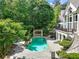 Aerial view of the pool and outdoor kitchen area, surrounded by lush greenery and patio space at 510 Covington Cv, Alpharetta, GA 30022