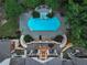 Aerial view of the luxurious pool and patio area, surrounded by lush greenery and featuring elegant outdoor seating at 510 Covington Cv, Alpharetta, GA 30022