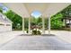 Grand portico with grand columns and patterned-brick driveway, with three car garage on left at 510 Covington Cv, Alpharetta, GA 30022