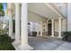 Covered portico with grand columns and stone accents offers a sheltered entryway to the home at 510 Covington Cv, Alpharetta, GA 30022