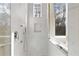 Modern shower features marble-style tile, a window, and sleek fixtures for a luxurious experience at 510 Covington Cv, Alpharetta, GA 30022
