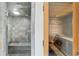 Spa area with tiled shower and sauna featuring wood paneling and a wooden bench at 510 Covington Cv, Alpharetta, GA 30022