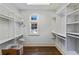 Walk-in closet with white shelving and storage space with a small window for natural light at 510 Covington Cv, Alpharetta, GA 30022