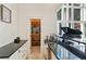 Wet bar with granite counters conveniently located next to the wine cellar and a grand piano at 510 Covington Cv, Alpharetta, GA 30022