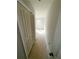 Hallway with closet and doorway to a room with natural light, offering storage solutions at 11612 E Lovejoy Rd, Hampton, GA 30228