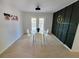 Well-lit dining room with a modern table, a decorative clock, and elegant wall accents at 208 Willows Ct, Riverdale, GA 30274