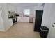 Bright kitchen with white cabinets, stainless steel appliances, and light wood floors at 208 Willows Ct, Riverdale, GA 30274