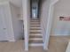 Staircase with light wood floors and white trim, leading to the upper level at 208 Willows Ct, Riverdale, GA 30274