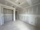 Unfinished bedroom featuring closet space, modern lighting, and smooth drywall ready for personalization at 2109 Stillhaven Pl, Douglasville, GA 30135