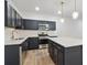 Modern kitchen featuring stainless steel appliances, an island, and navy blue cabinets with gold hardware at 2109 Stillhaven Pl, Douglasville, GA 30135