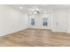 Bright living room with wood floors, neutral walls, ceiling fan and windows at 2109 Stillhaven Pl, Douglasville, GA 30135