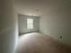 Bare bedroom space featuring a single window, with bare walls, floor and ceiling at 35 Emerald Ln, Covington, GA 30014