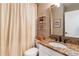 Cozy bathroom featuring granite countertops, a framed mirror, and stylish shelving for storage at 3770 Summit Gate Dr, Suwanee, GA 30024