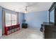 Bright, carpeted bedroom with blue walls, ceiling fan, and ample natural light from a large window at 3770 Summit Gate Dr, Suwanee, GA 30024