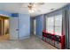 Spacious bedroom with bright blue walls, light carpet, ceiling fan and a large window at 3770 Summit Gate Dr, Suwanee, GA 30024