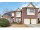 Lovely two story brick home featuring an attached two car garage and manicured lawn at 3770 Summit Gate Dr, Suwanee, GA 30024