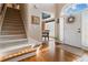 Bright foyer featuring hardwood floors, a white front door with glass, and staircase to the second floor at 3770 Summit Gate Dr, Suwanee, GA 30024