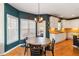 Bright breakfast nook featuring hardwood floors, a table and chair set, and white kitchen cabinets at 3770 Summit Gate Dr, Suwanee, GA 30024