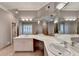 Bright bathroom featuring a long vanity with dual sinks and a soaking tub at 3871 River Mansion Dr, Peachtree Corners, GA 30096