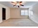 Bedroom featuring neutral carpet, ceiling fan, and window at 3871 River Mansion Dr, Peachtree Corners, GA 30096