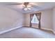 Neutral bedroom with neutral carpet, window, and ceiling fan at 3871 River Mansion Dr, Peachtree Corners, GA 30096