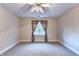 Spacious neutral bedroom features carpet, natural light, a ceiling fan, and a window at 3871 River Mansion Dr, Peachtree Corners, GA 30096