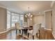 Cozy dining room with hardwood floors, chandelier, and window seat by large bright windows at 3871 River Mansion Dr, Peachtree Corners, GA 30096