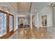 Elegant foyer view with hardwood floors, dining area, and decorative glass entry at 3871 River Mansion Dr, Peachtree Corners, GA 30096