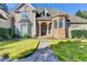 Elegant home entrance featuring arched doorways and stone walkway to the front door at 3871 River Mansion Dr, Peachtree Corners, GA 30096