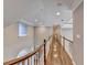 Long hallway with hardwood floors, crown molding, and natural light at 3871 River Mansion Dr, Peachtree Corners, GA 30096