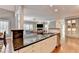 Stylish kitchen island with seating, stainless steel sink, and black granite countertops at 3871 River Mansion Dr, Peachtree Corners, GA 30096