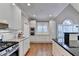 Contemporary kitchen with stainless steel appliances, white cabinets, and hardwood floors at 3871 River Mansion Dr, Peachtree Corners, GA 30096