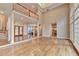 Bright living room featuring hardwood floors, a balcony, an open floor plan, and a staircase at 3871 River Mansion Dr, Peachtree Corners, GA 30096