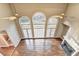 Spacious living room featuring fireplace, hardwood floors, and large arched windows at 3871 River Mansion Dr, Peachtree Corners, GA 30096