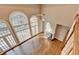 Bright living room with hardwood floors, fireplace, and large arched windows at 3871 River Mansion Dr, Peachtree Corners, GA 30096