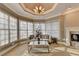 Bright and airy living room featuring a trey ceiling, fireplace, and large windows at 3871 River Mansion Dr, Peachtree Corners, GA 30096